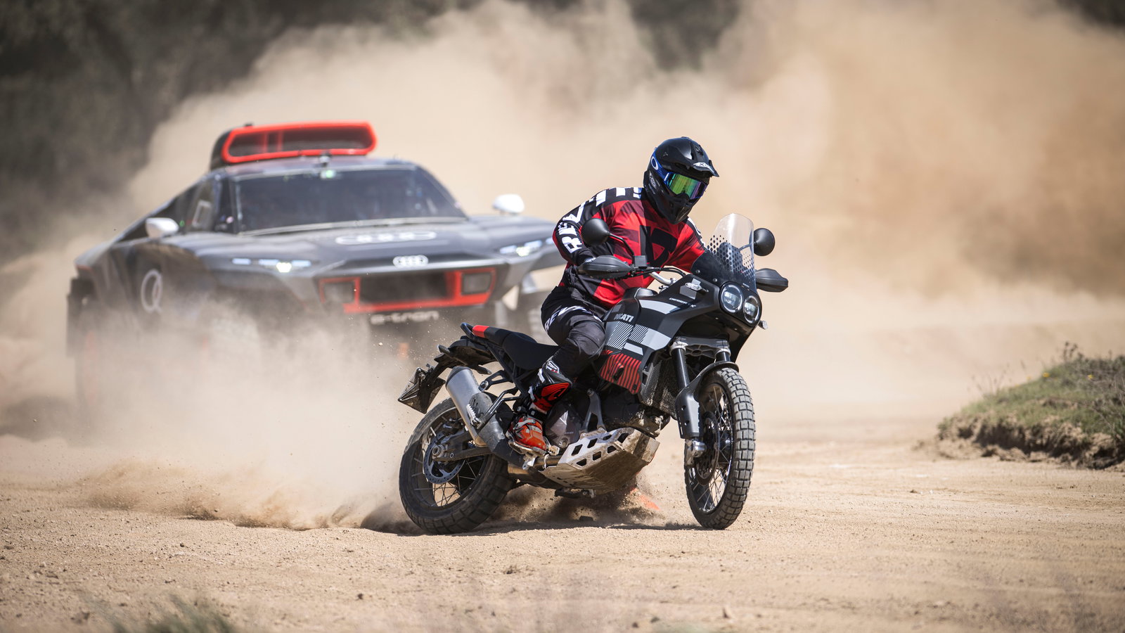 Danilo Petrucci on Ducati DesertX with Carlos Sainz in Audi RS Q e-tron, Sardegna promo. - Ducati Media